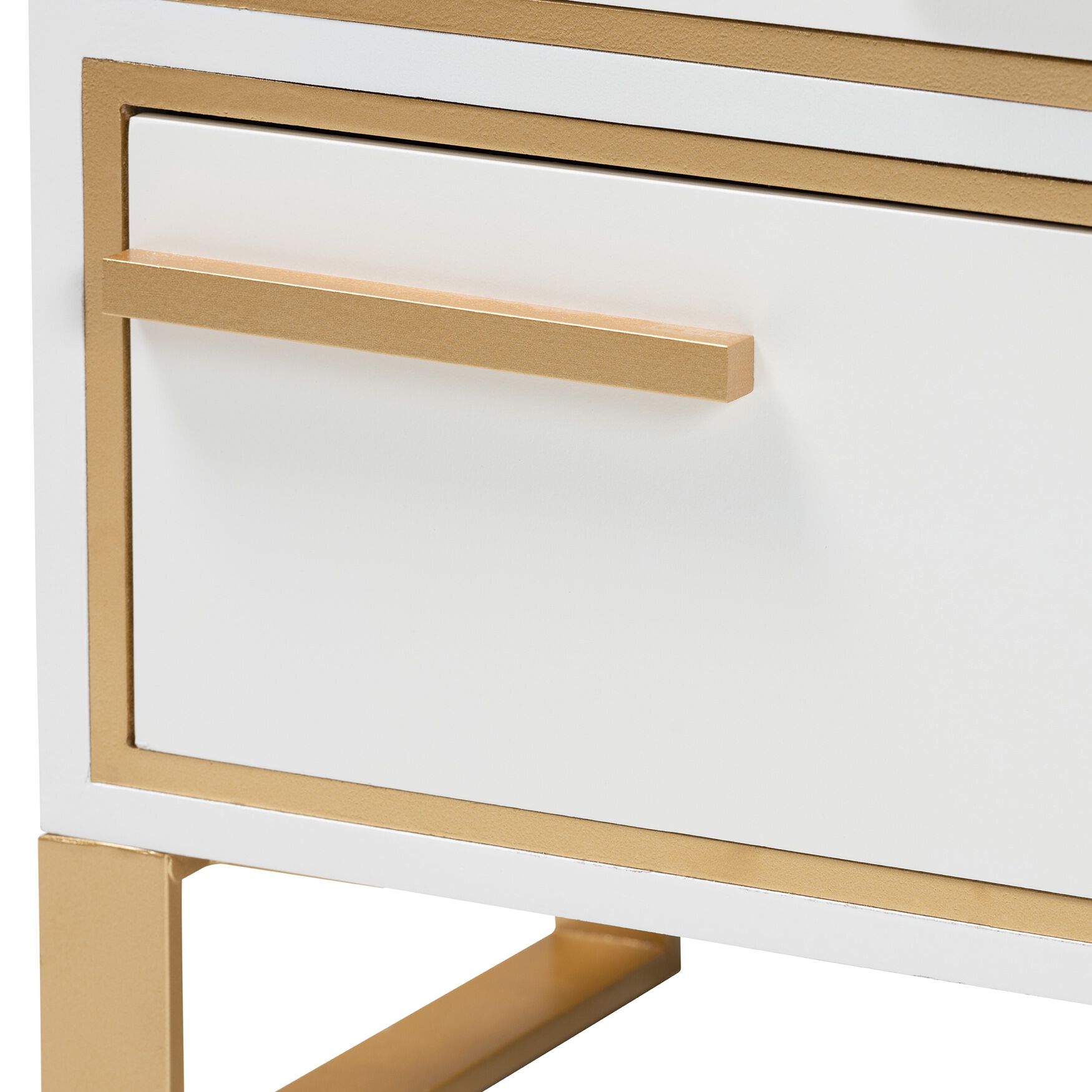 Close-up of a white drawer with gold metal handle and trim