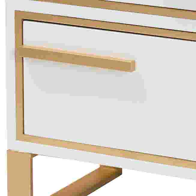 Close-up of a white drawer with gold metal handle and trim