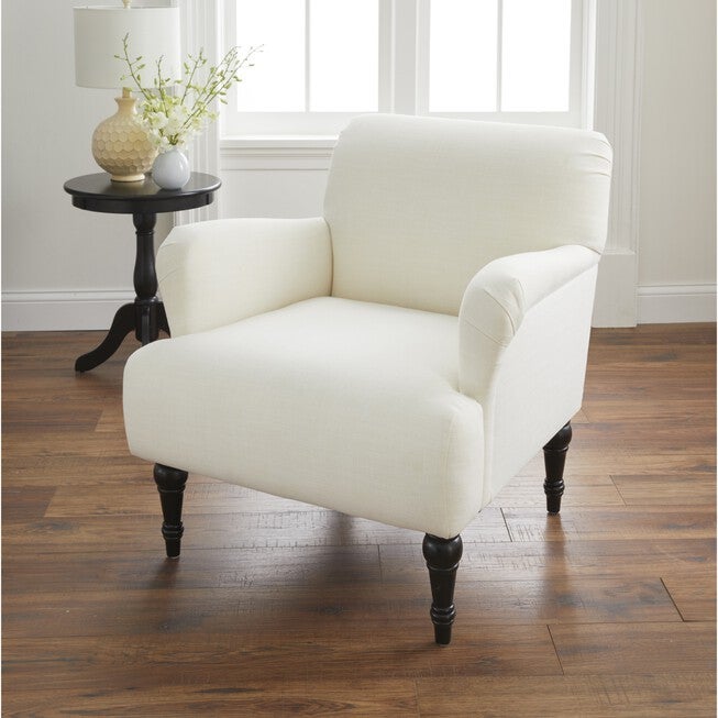 Cream upholstered armchair with dark turned legs in living room