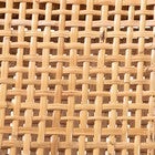 Close-up of natural rattan weaving pattern on stool backrest