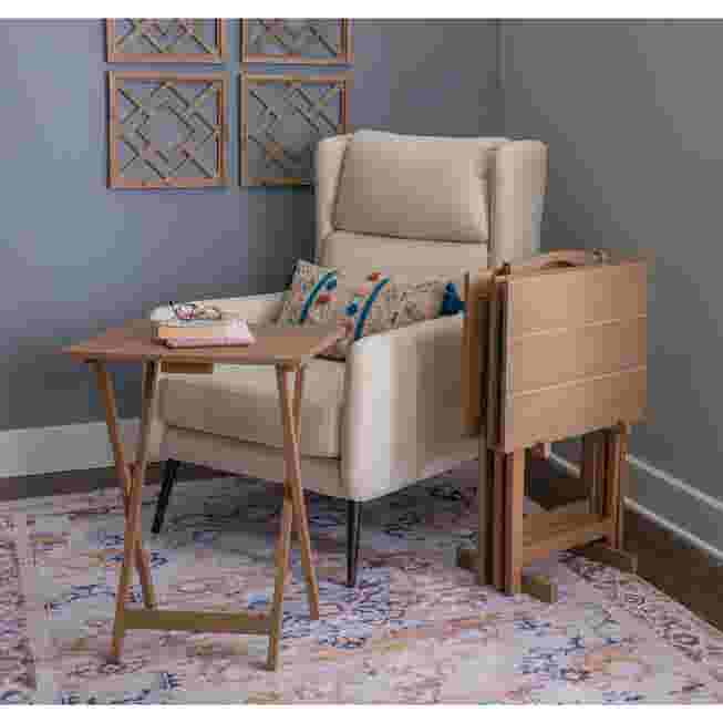 Desk setup with foldable table beside armchair in living room