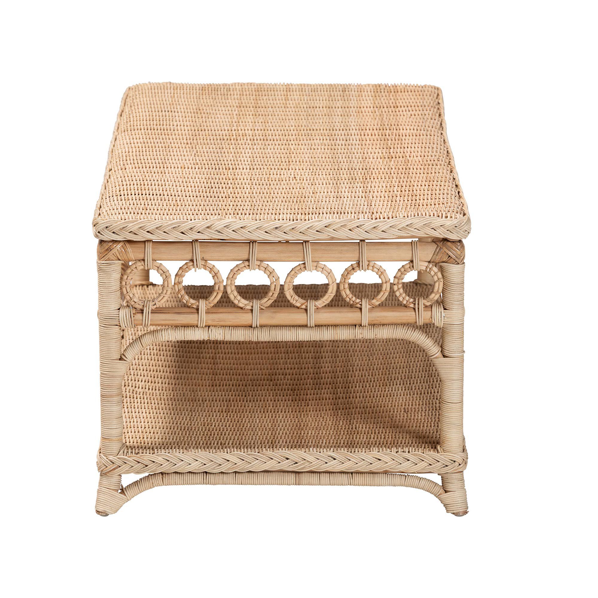 Natural rattan coffee table with a rectangular top and decorative cutouts, shown against a white background.