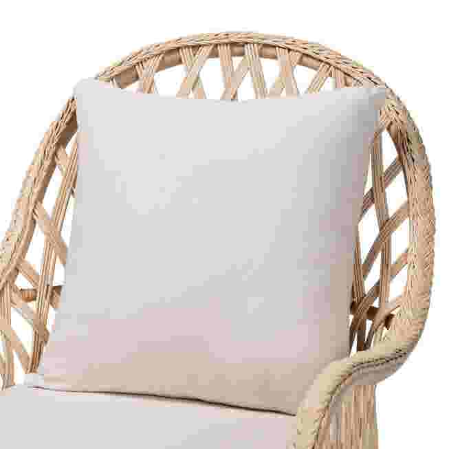Cushion against backrest of rattan arm chair