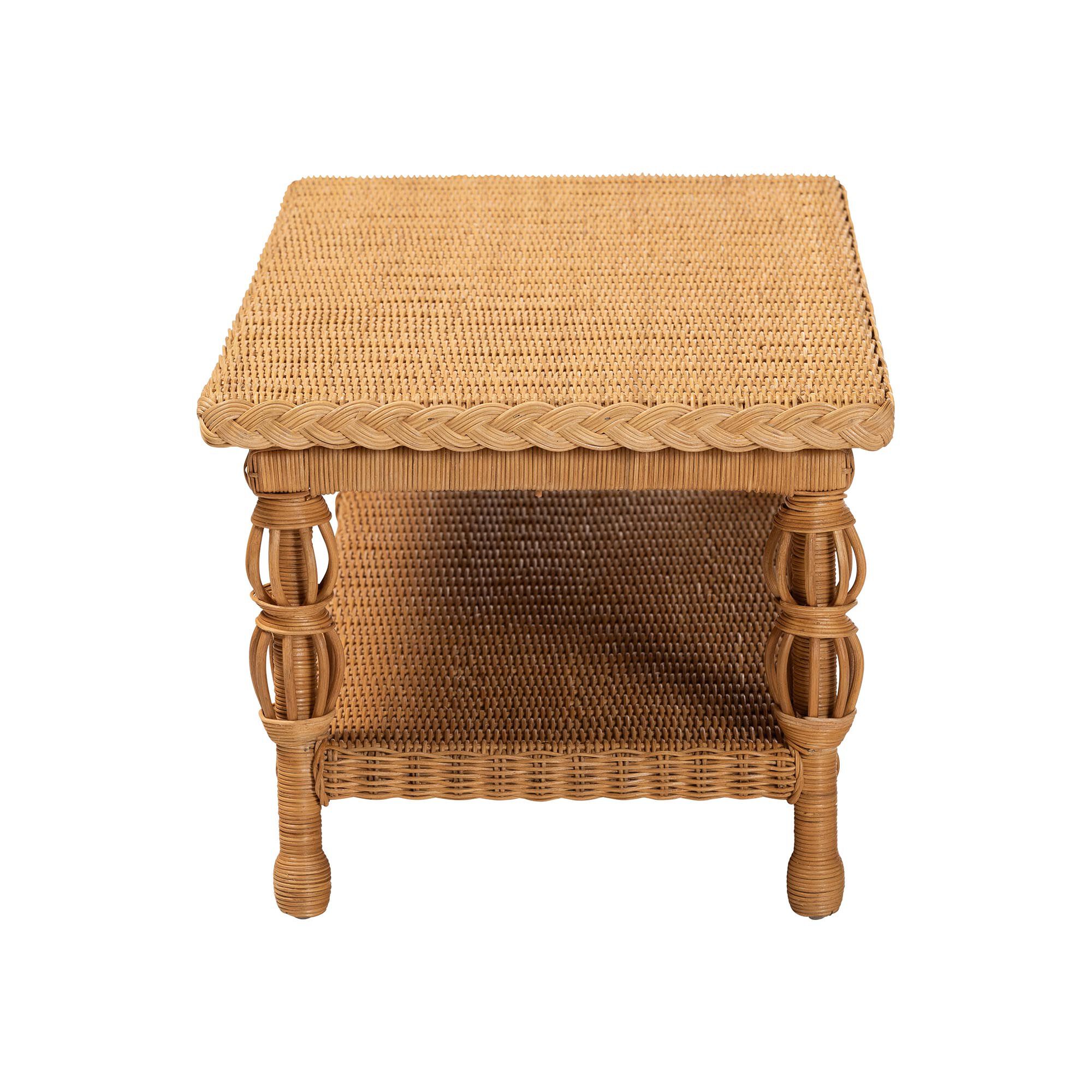 Natural rattan coffee table with a woven top and lower shelf, shown against a white background.