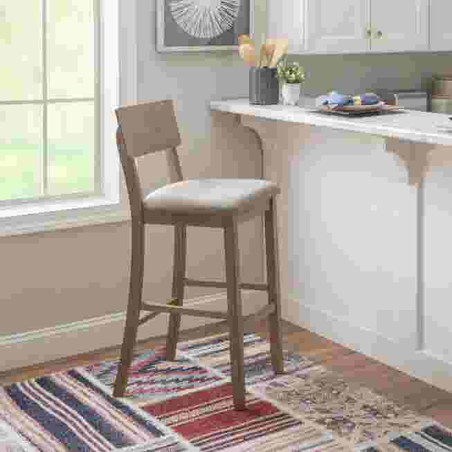 Jordan gray wash bar stool in kitchen with patterned rug