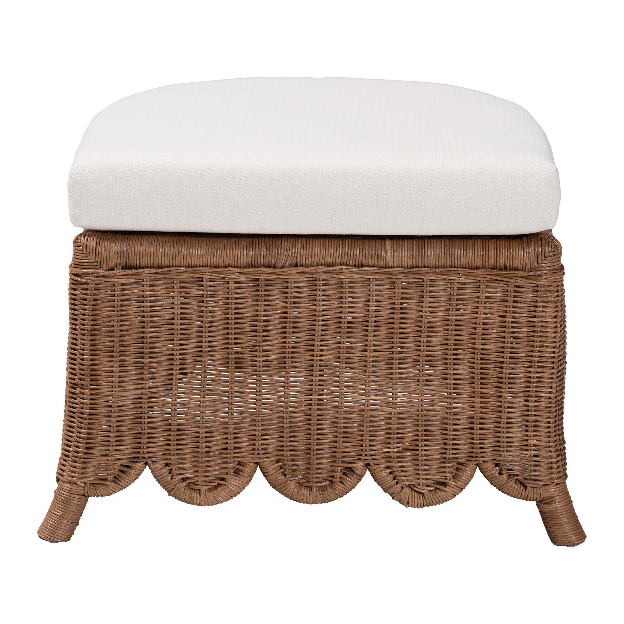 Natural rattan footstool with white cushion on a white background