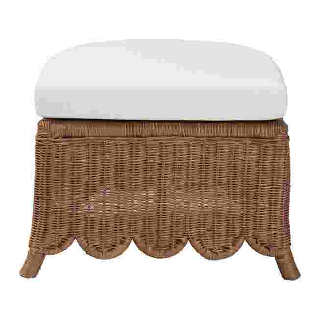 Natural rattan footstool with white cushion on a white background