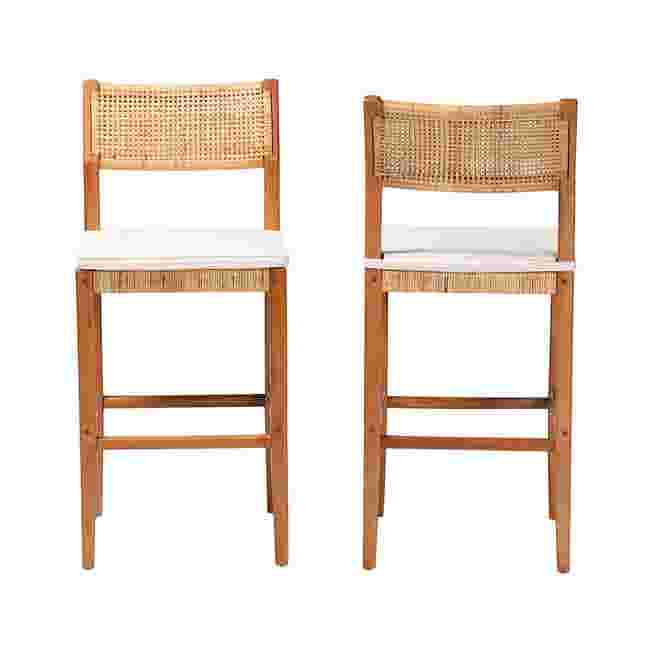 Two bar stools shown from front, caned backs and white seats