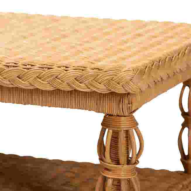 Close-up of the woven top and leg of the rattan coffee table.
