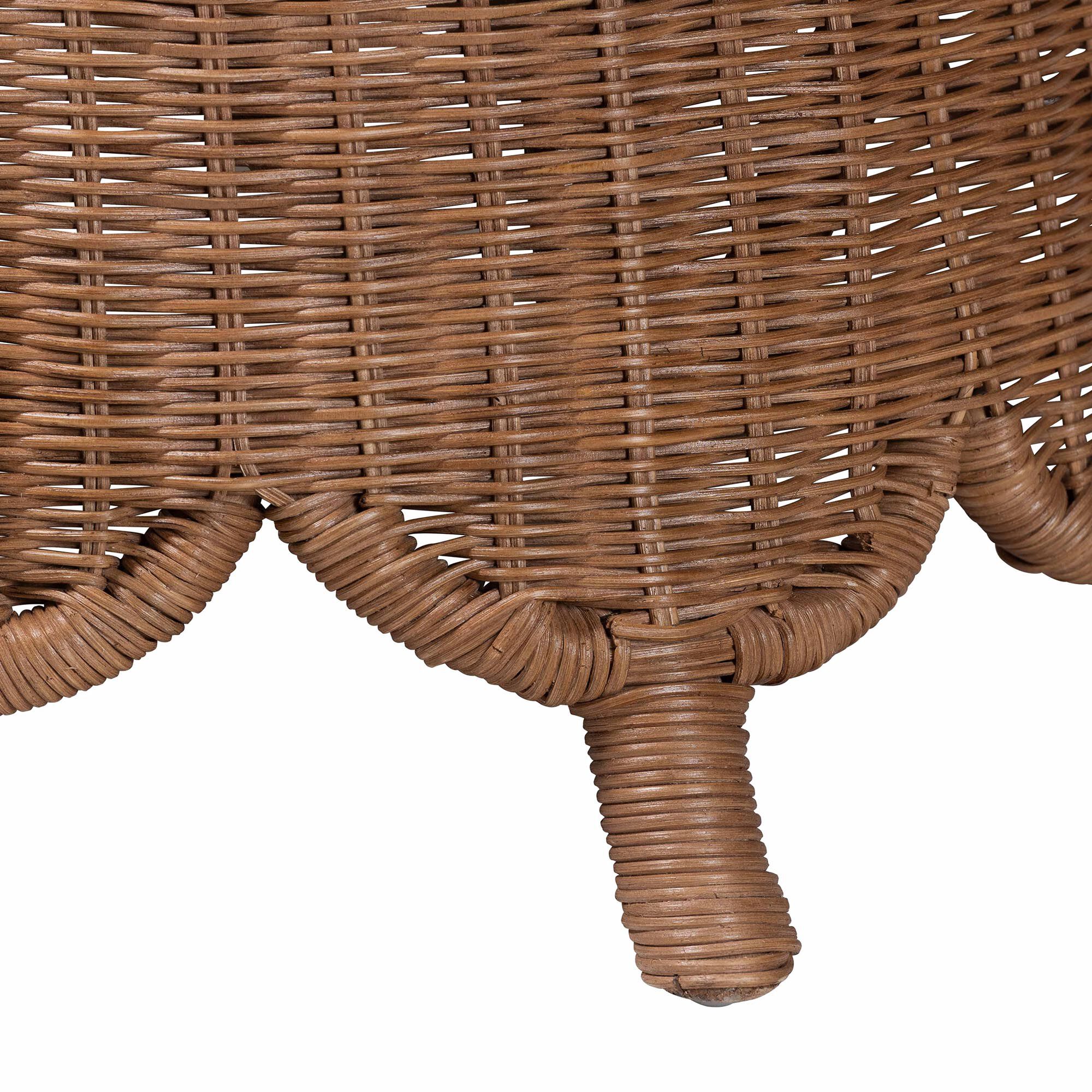 Close-up of the rattan footstool's leg and base