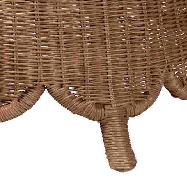 Close-up of the rattan footstool's leg and base