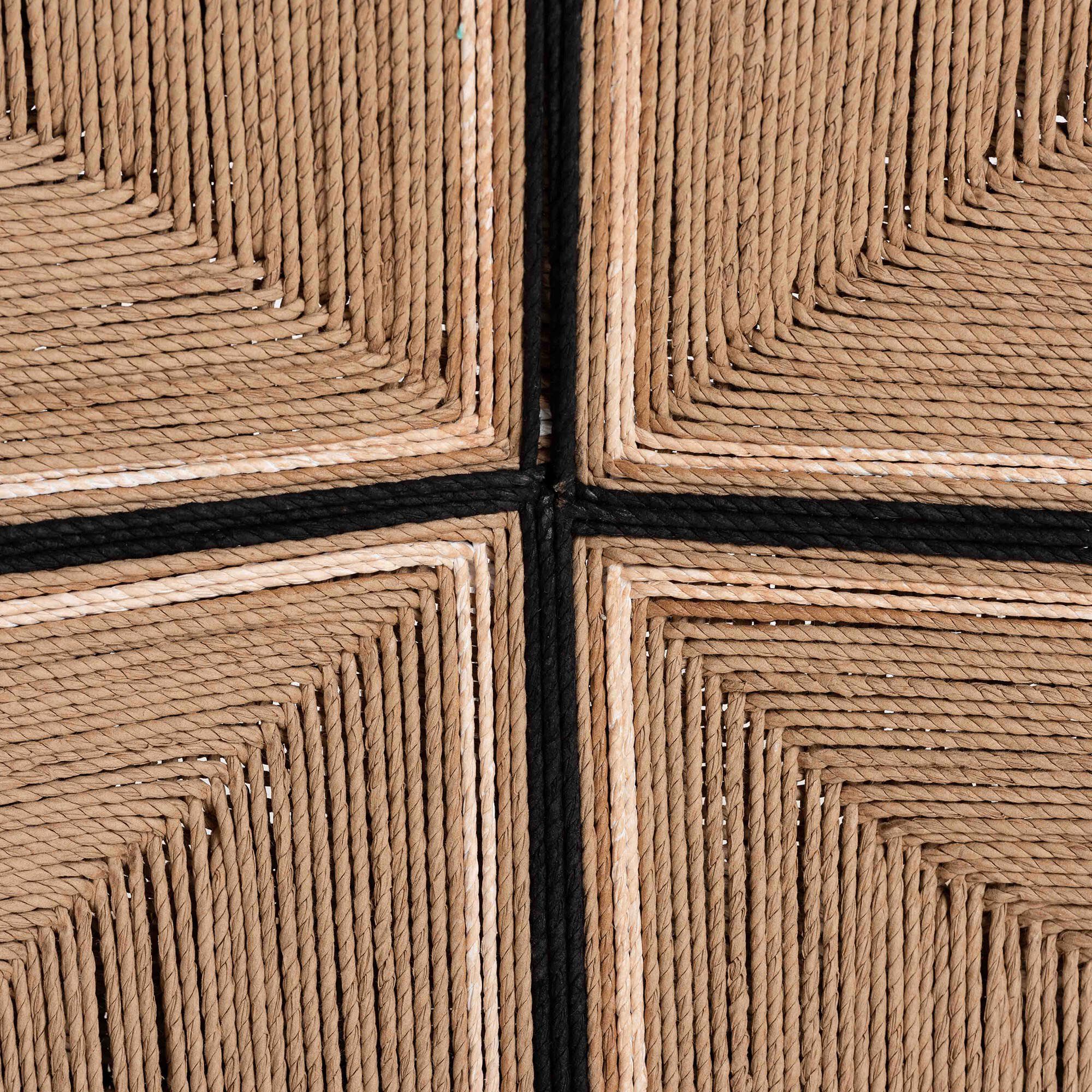 Close-up of woven paper-loom pattern with dark stitch lines