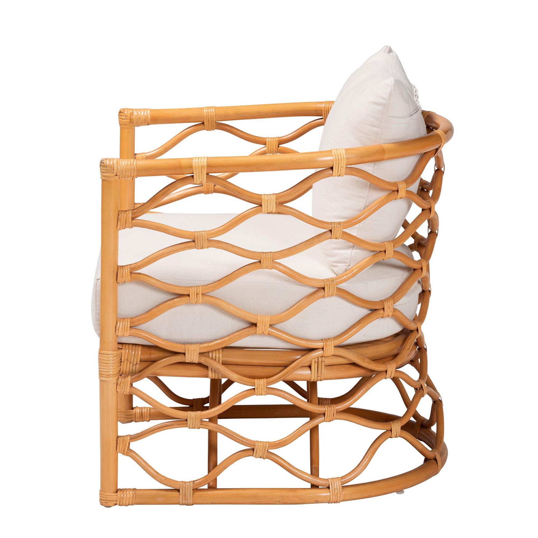 Side view of light honey rattan arm chair with white cushion