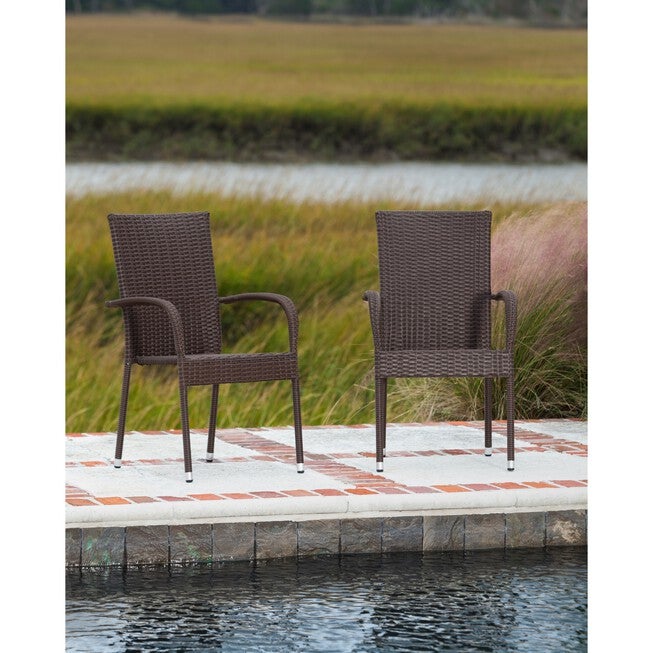 Mocha outdoor wicker stacking chair on a patio deck near water