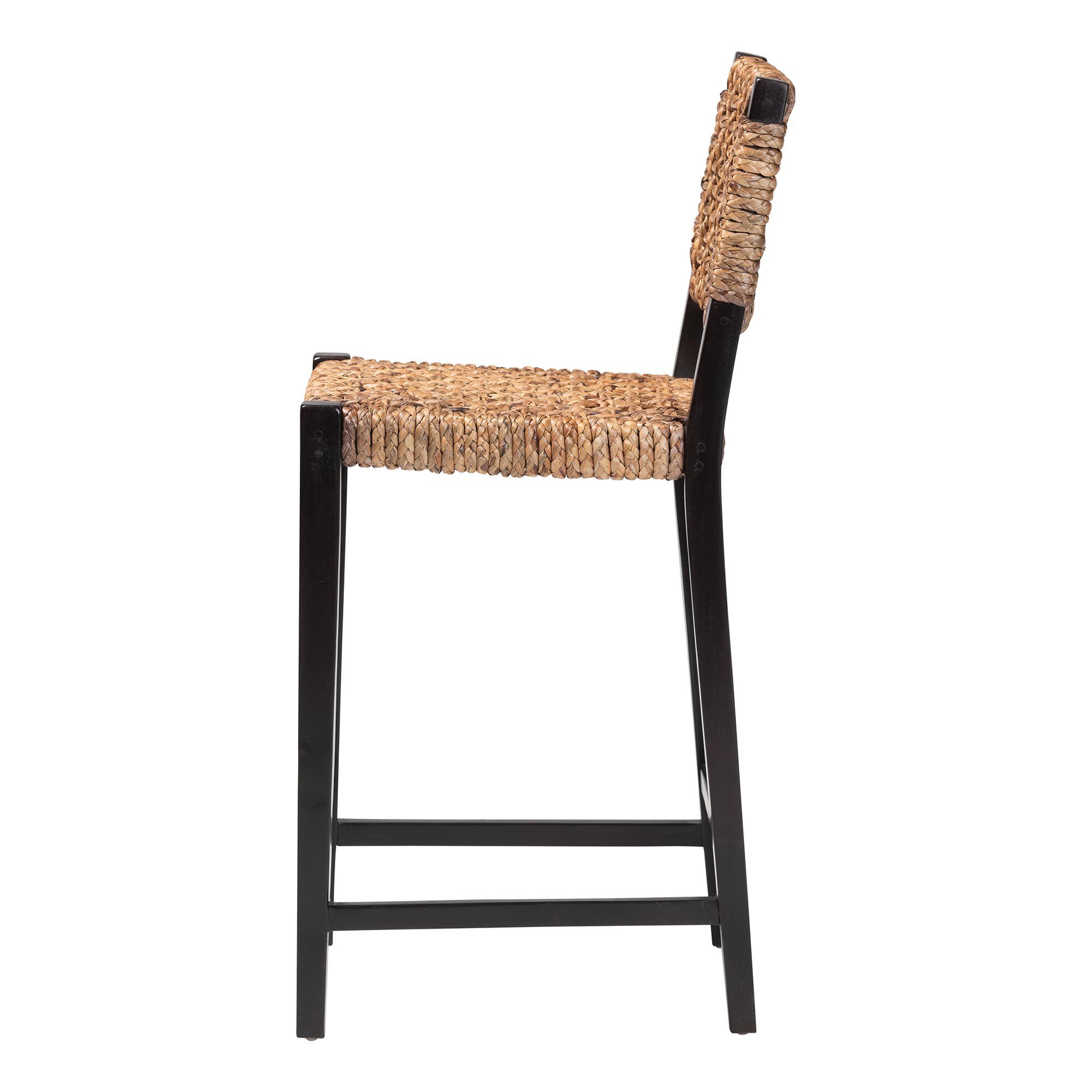 Side view of a seagrass bar stool with a black frame.