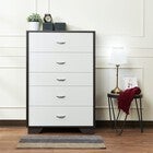 White chest of drawers with dark frame in a home setting