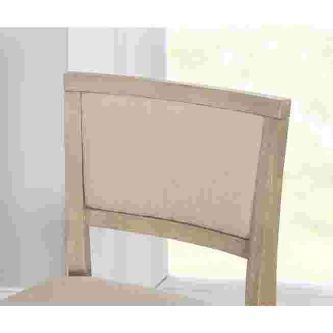 Close-up of the backrest of a grey wash folding bar stool