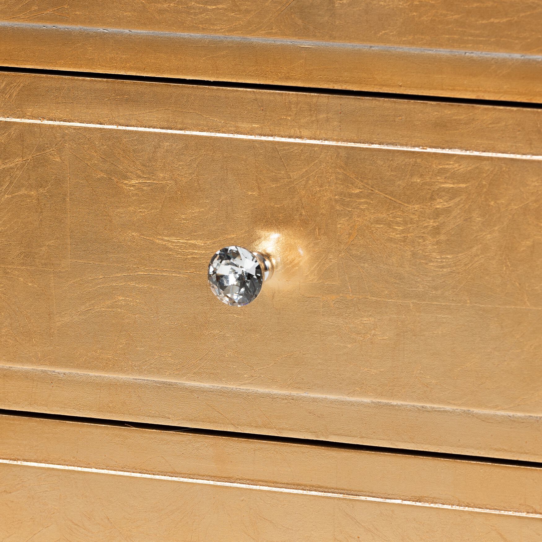Close-up of knob on gold nightstand drawer