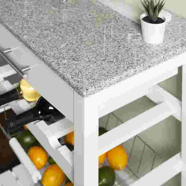 Close view of white kitchen island open shelf with granite countertop