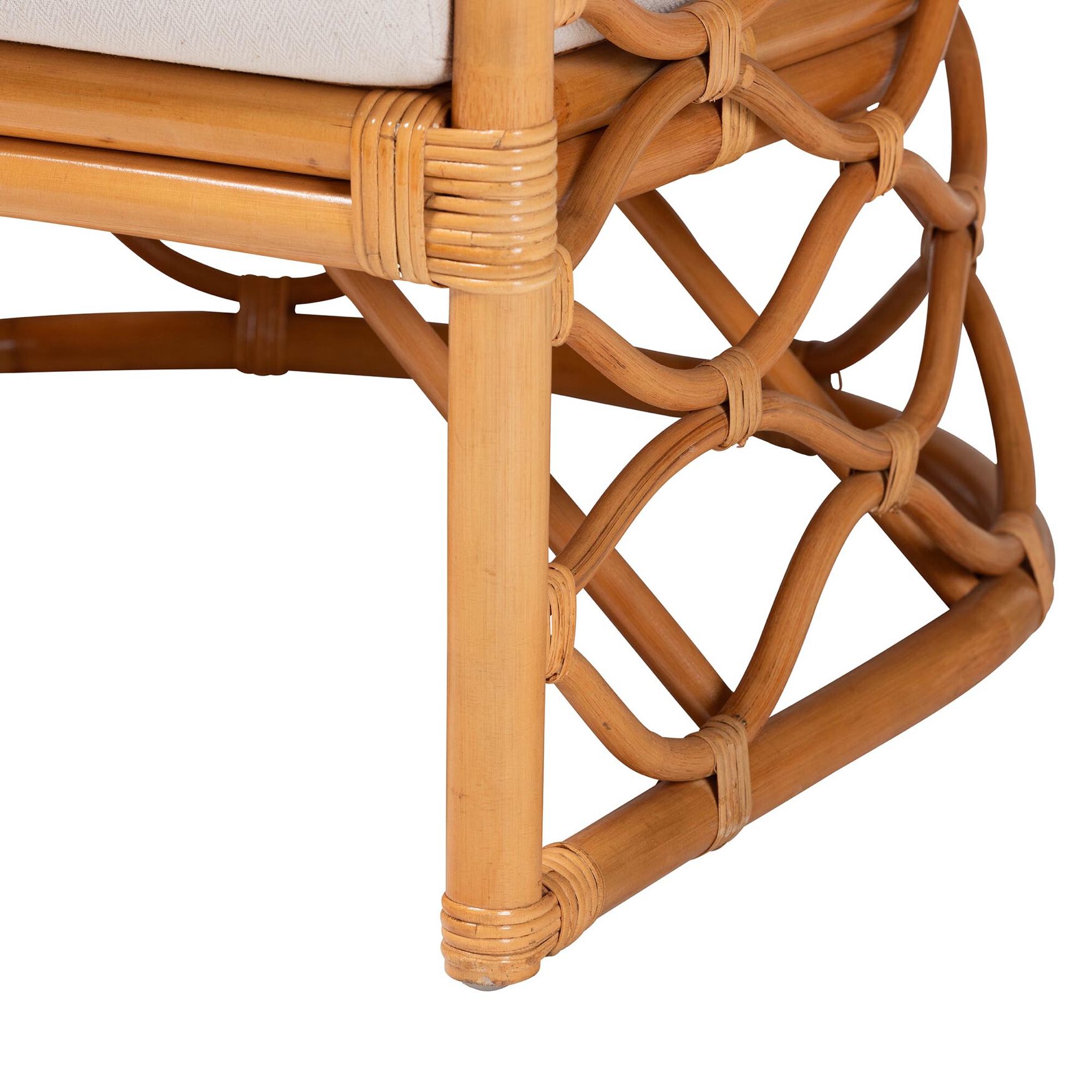 Close-up of rattan frame and leg of light honey arm chair