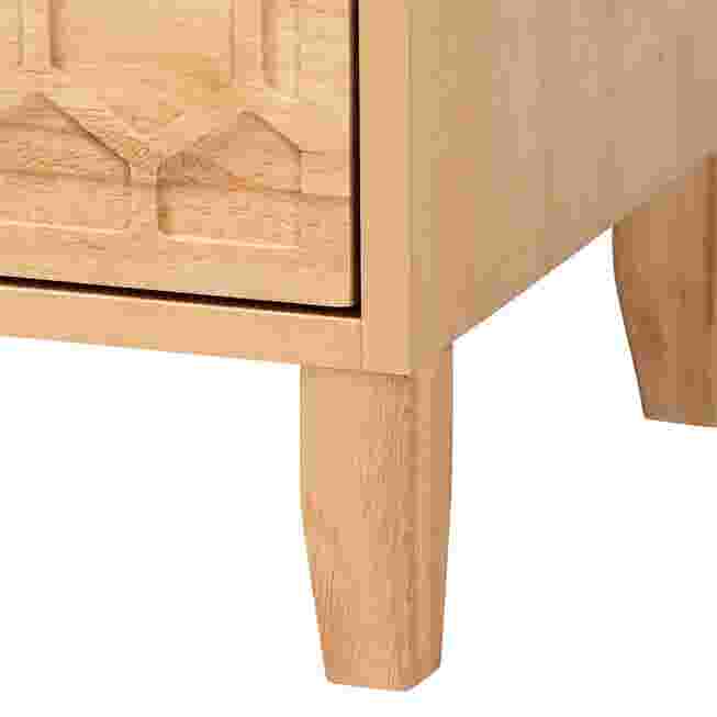 Close-up of honeycomb carved drawer front and tapered leg on nightstand