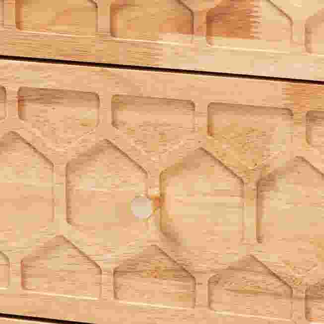 Close-up of honeycomb carved drawer front and knob on nightstand