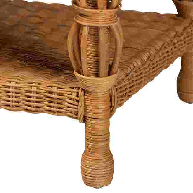 Close-up of the woven leg and shelf of the rattan coffee table.