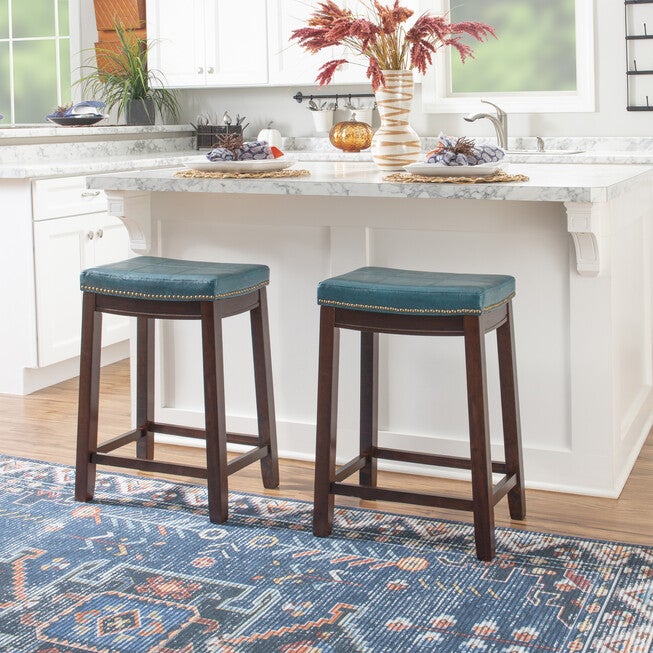 Claridge faux leather bar stools with teal upholstered seats and nailhead trim