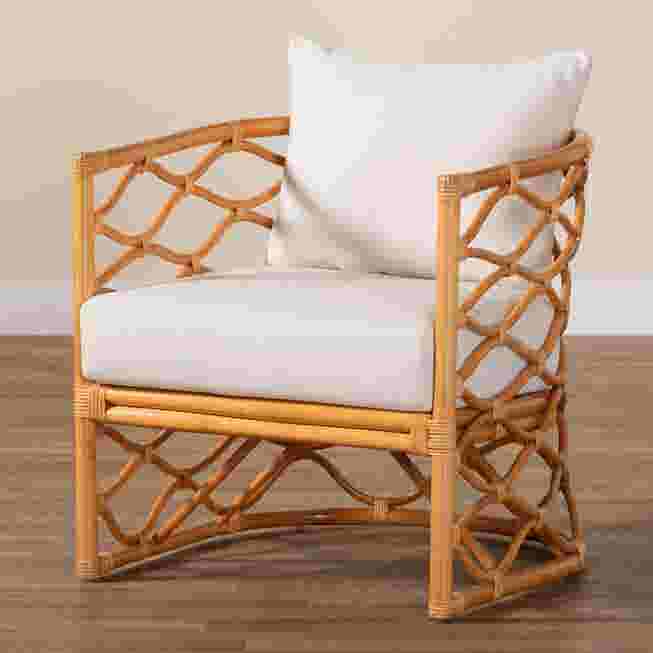 Light honey rattan arm chair with white cushion on wooden floor