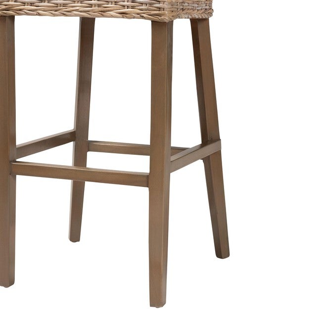 Detail of mahogany legs and ladder footrest on rattan bar stool.