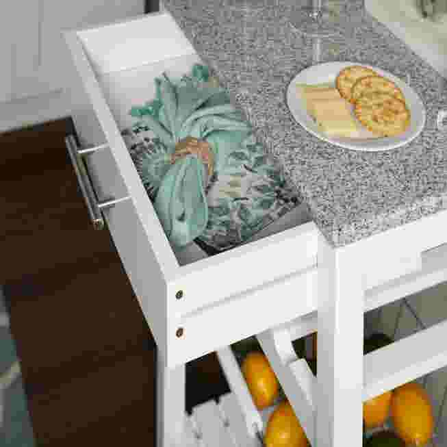 White kitchen island with granite top and open side storage