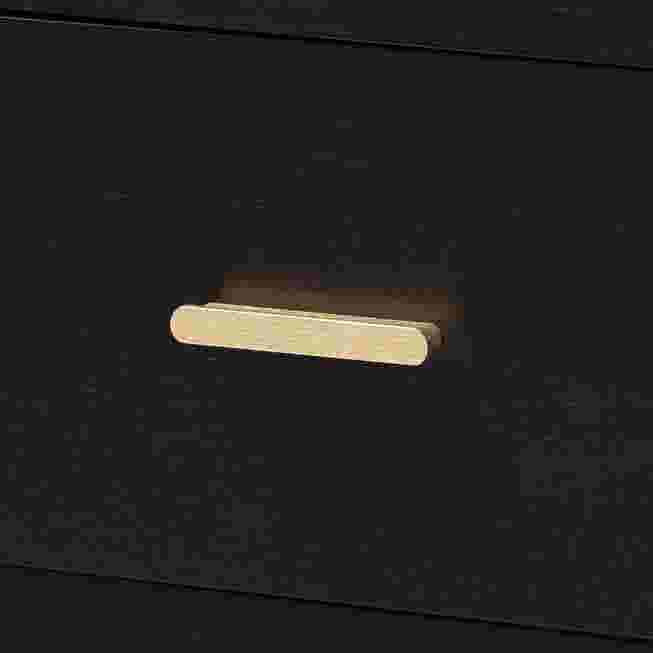 Close-up of gold bar pull on black Marisela nightstand drawer