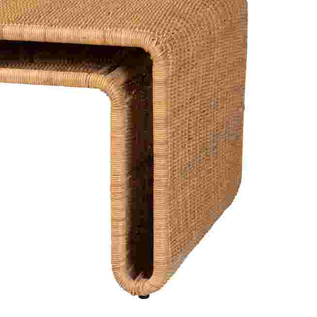 Close-up of the corner of a light honey rattan coffee table