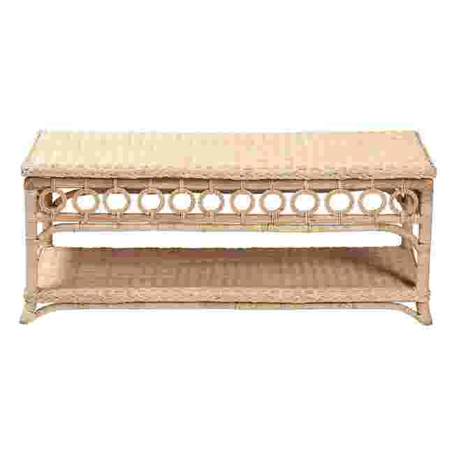Natural rattan coffee table with a rectangular top and decorative cutouts, shown against a white background.
