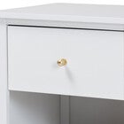 Close-up of white nightstand drawer face with gold knob