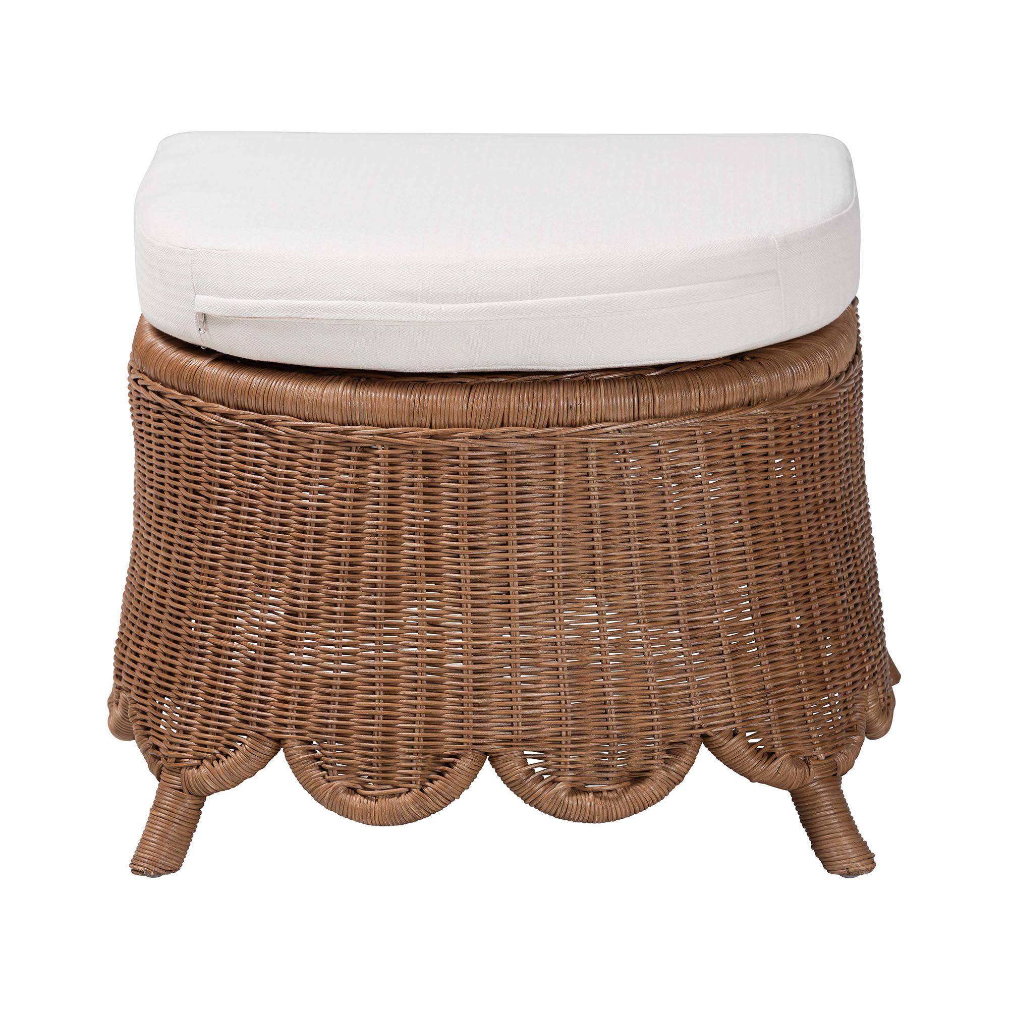 Natural rattan footstool with white cushion on a white background