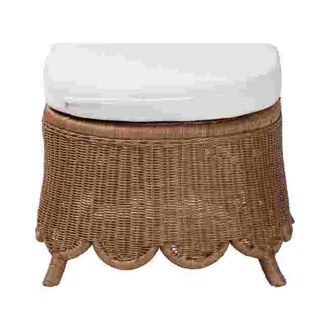 Natural rattan footstool with white cushion on a white background