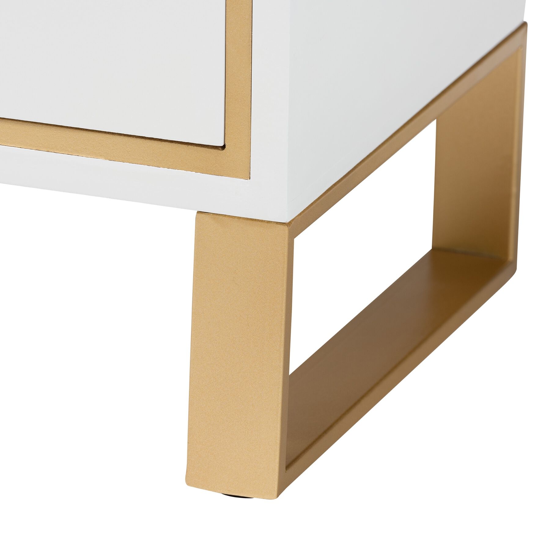 Close-up of the gold metal leg of a white nightstand