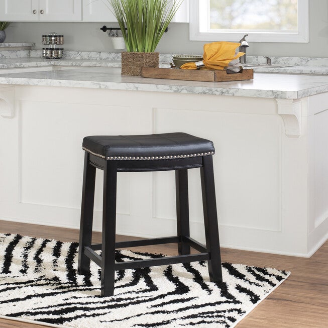 Claridge faux leather upholstered bar stool in dark brown with nailhead trim