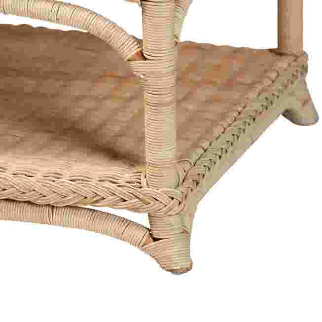 Close-up of the rattan coffee table's leg and lower shelf, showing the woven texture.