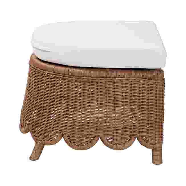 Natural rattan footstool with white cushion on a white background